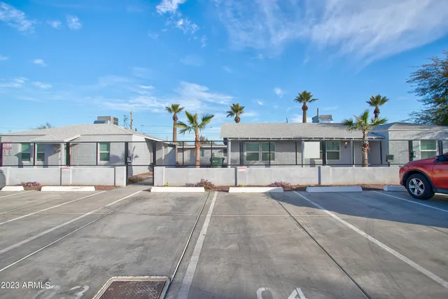 a view of a house with a yard and sitting area