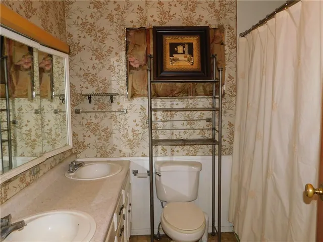 a bathroom with a toilet sink and shower