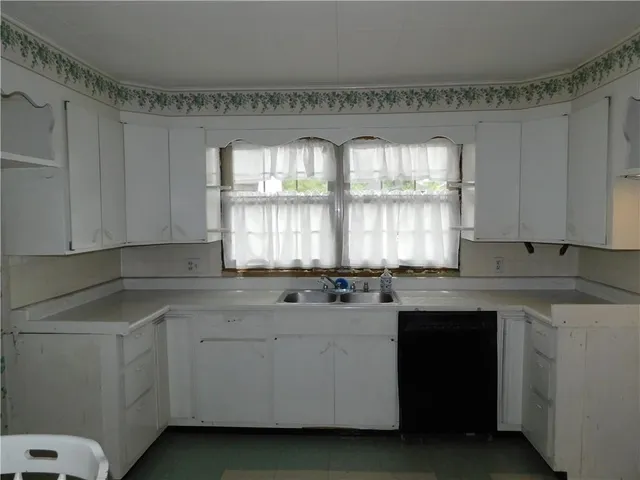 a dining room with a sink and a mirror