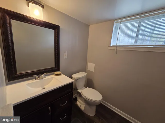a bathroom with a sink a toilet and mirror