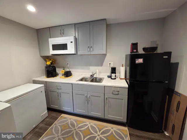 a kitchen with a sink cabinets and appliances