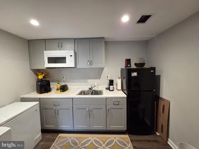 a kitchen with a sink and cabinets
