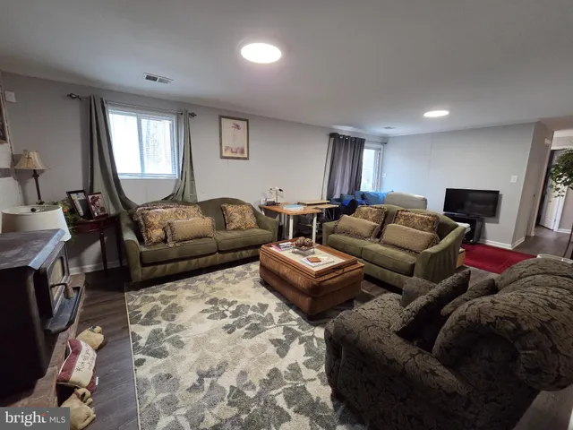 a living room with furniture a window and a flat screen tv