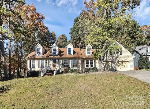 a front view of a residential apartment building with a yard