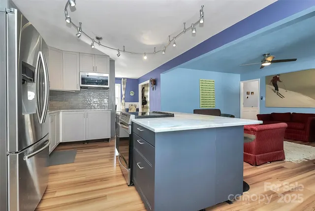 a kitchen with granite countertop a sink stainless steel appliances and cabinets