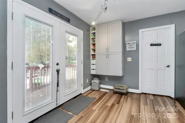 a view of a room with wooden floor and a gate