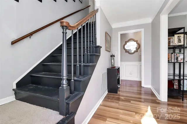 a view of entryway and hall with wooden floor