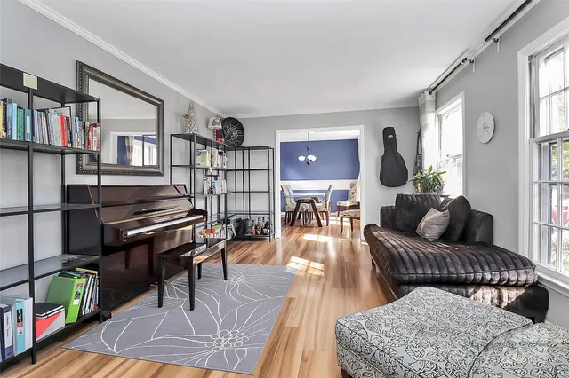 a living room with furniture and a book shelf