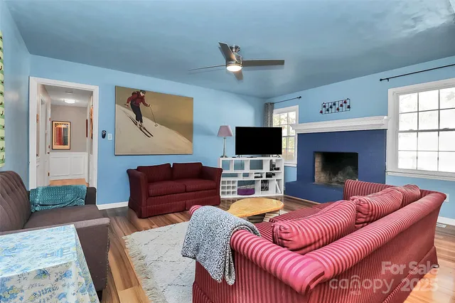 a living room with furniture fireplace and flat screen tv