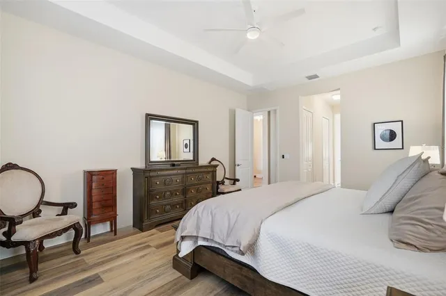 a bedroom with a bed and wooden floor
