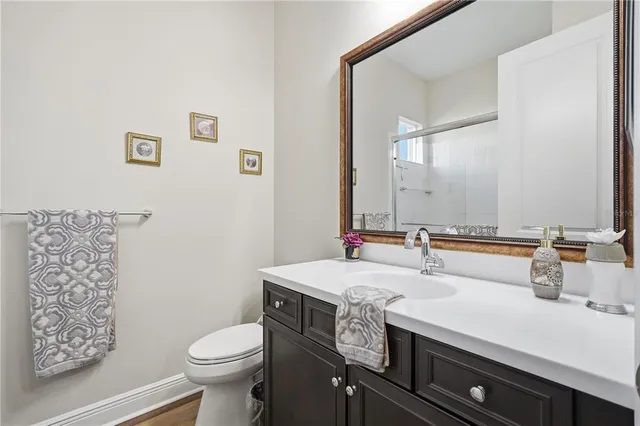 a bathroom with a sink toilet and mirror