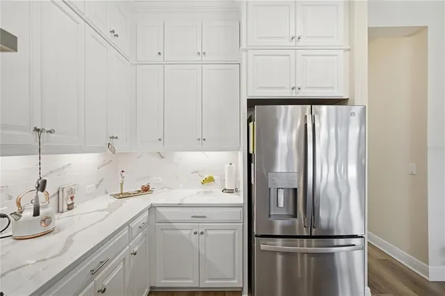 a kitchen with a refrigerator and cabinets