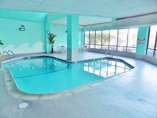 a view of a swimming pool with an outdoor seating