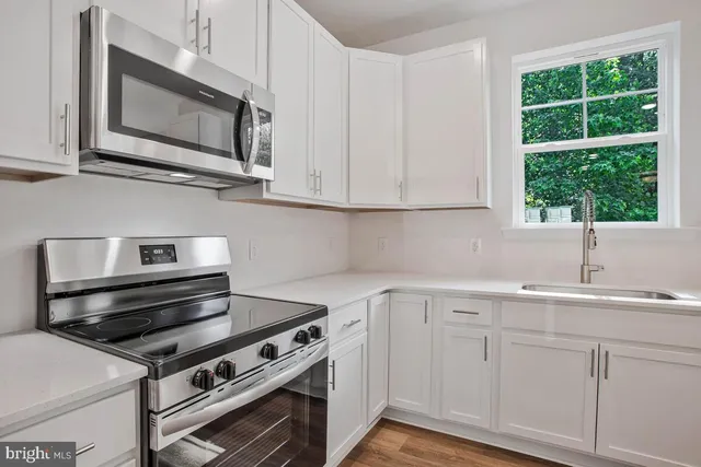a view of kitchen with wooden floor and window