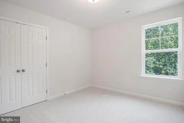 a view of an empty room and a window