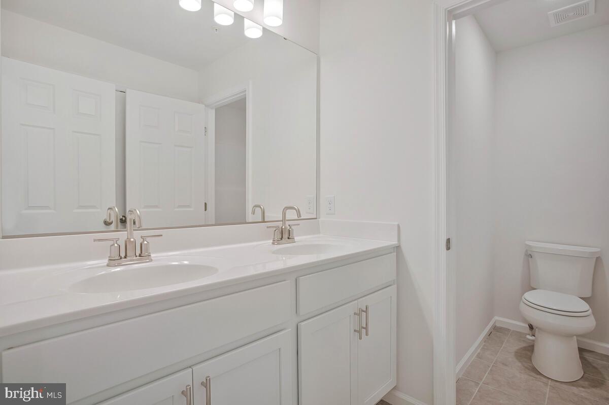 404 Warwick Place Edgewater, MD 21037 - Photo 25 of 76 a bathroom with a sink toilet and a mirror