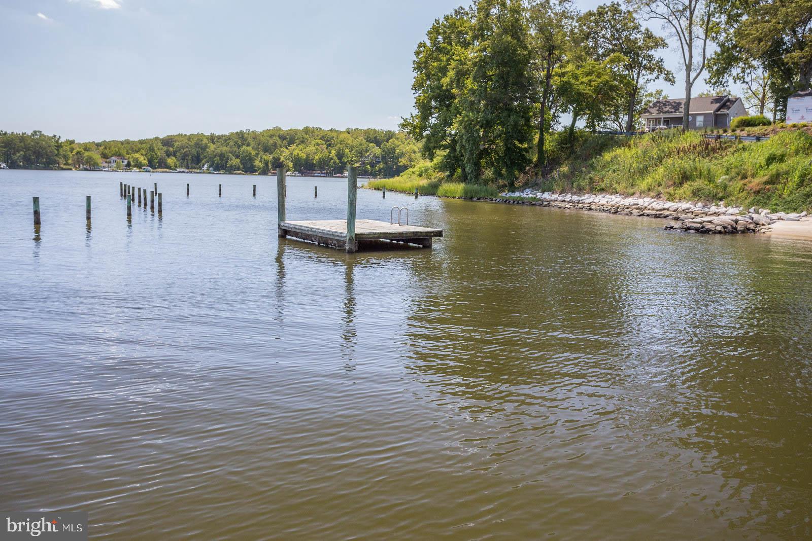 404 Warwick Place Edgewater, MD 21037 - Photo 42 of 76 a view of a lake with houses in the back