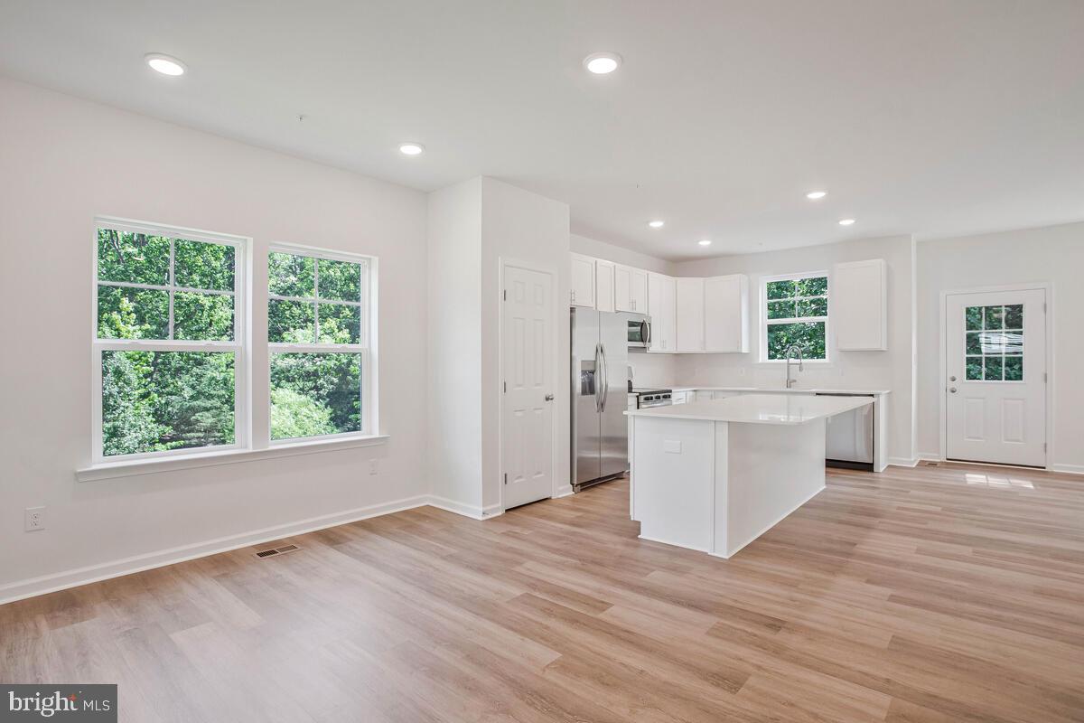 404 Warwick Place Edgewater, MD 21037 - Photo 5 of 76 a view of a kitchen with wooden floor and electronic appliances