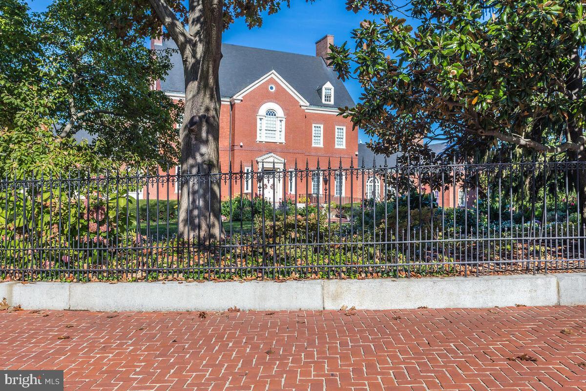 404 Warwick Place Edgewater, MD 21037 - Photo 65 of 76 a view of a brick house next to a yard with large trees
