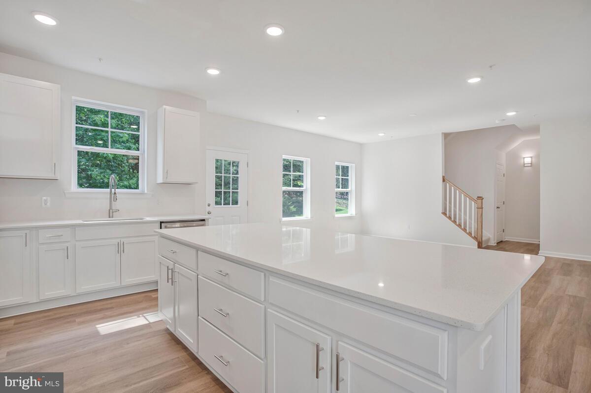 404 Warwick Place Edgewater, MD 21037 - Photo 9 of 76 a large white kitchen with granite countertop a sink and dishwasher with a large window