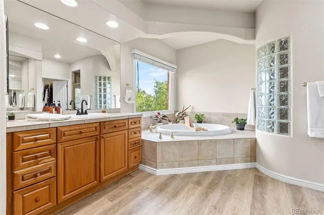 a large white kitchen with a large window