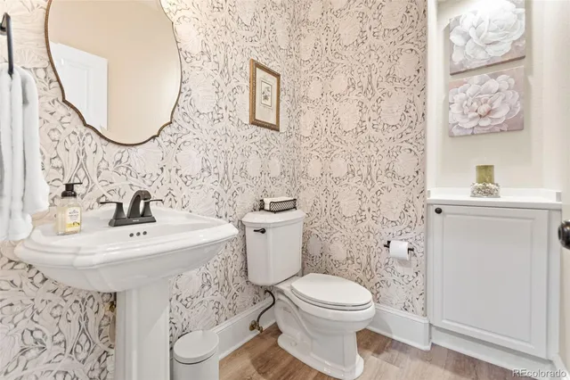 a bathroom with a sink toilet and a mirror
