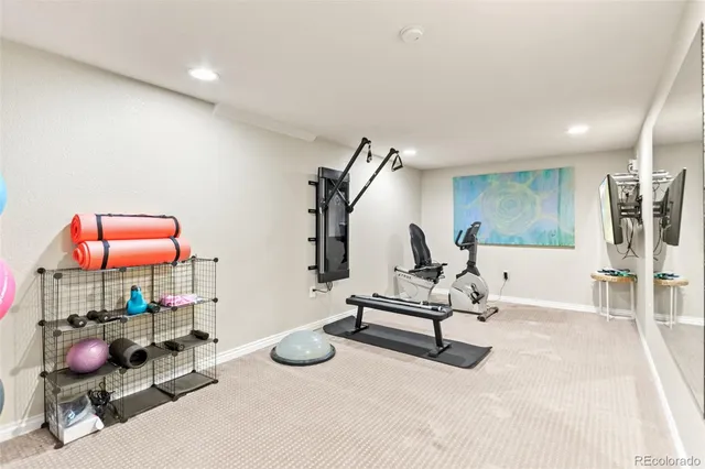 a living room with furniture and gym equipment