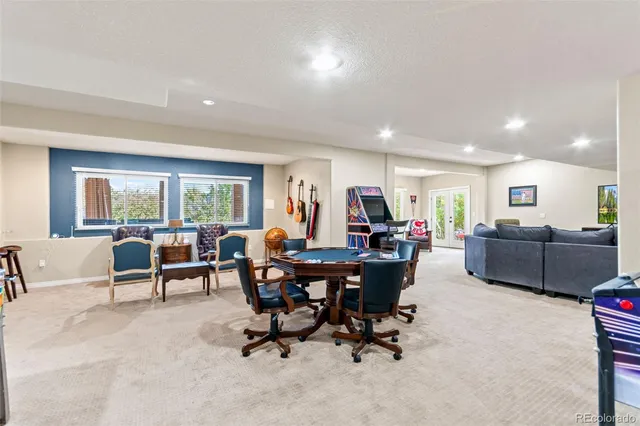 a living room with furniture kitchen view and a large window
