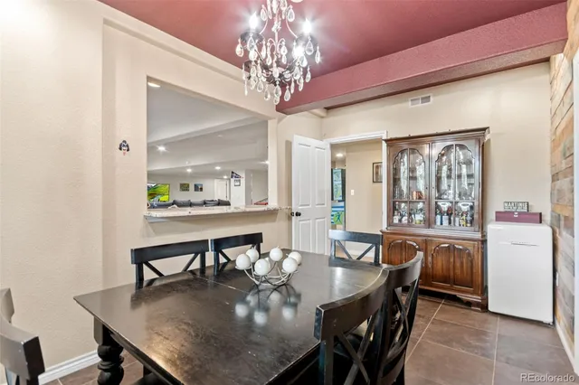 a view of a dining room with furniture and chandelier