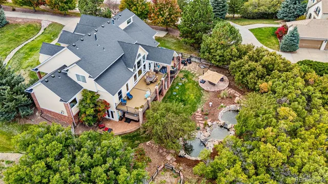 an aerial view of a house with a yard and garden
