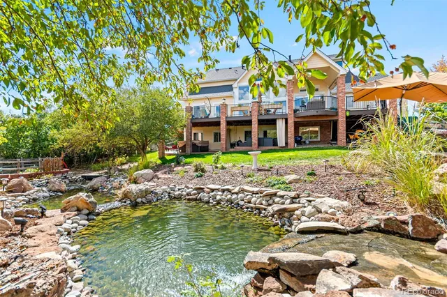 a view of a house with swimming pool and a yard