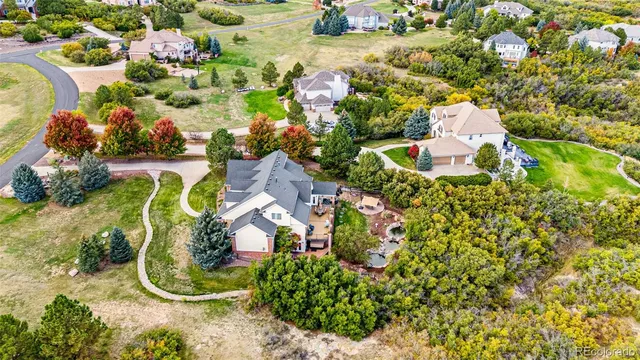 an aerial view of a house with swimming pool and outdoor space