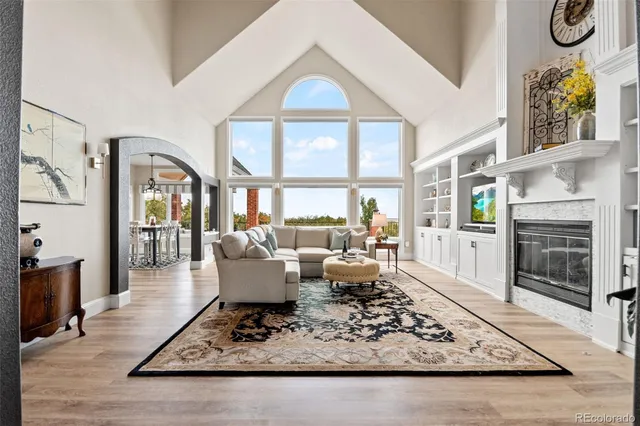 a living room with fireplace furniture and a floor to ceiling window