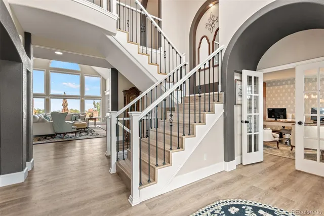 a view of staircase with lots of frames and frames on wall next to a window