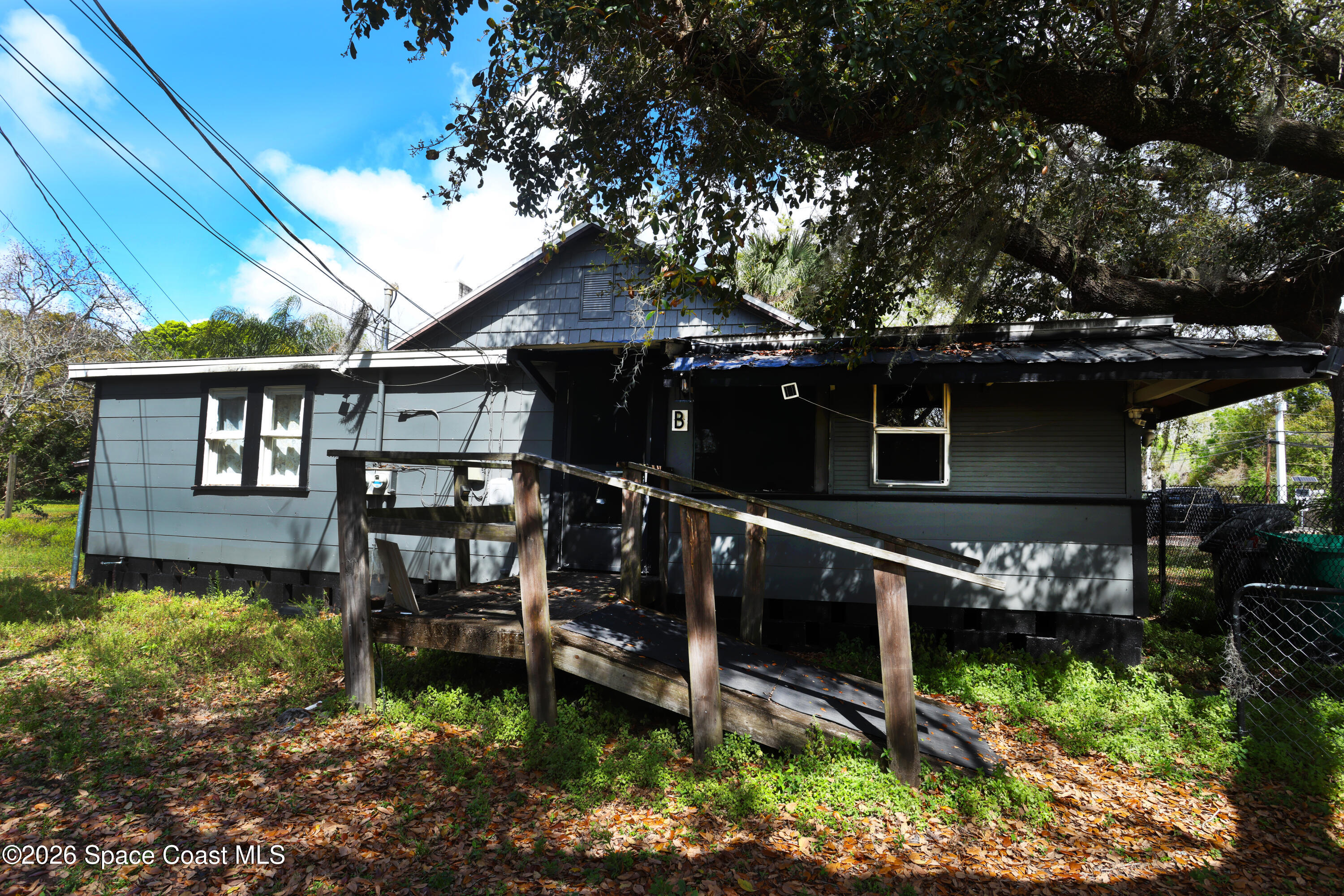 317 Pineda Street, Unit B Cocoa, FL 32922 - Photo 1 of 19 a backyard of a house with lots of green space