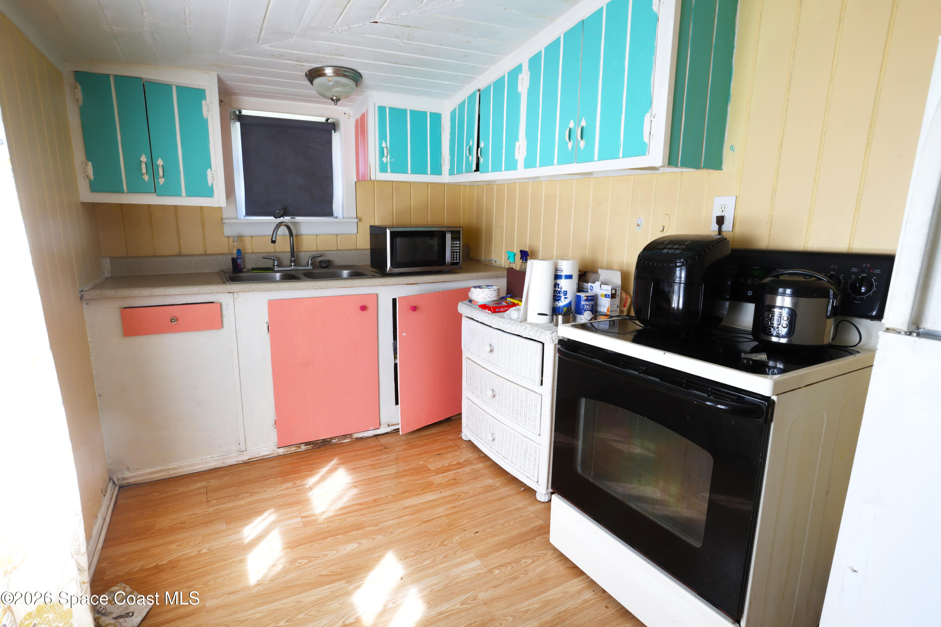317 Pineda Street, Unit B Cocoa, FL 32922 - Photo 14 of 19 a kitchen with stainless steel appliances granite countertop a stove a sink and a microwave