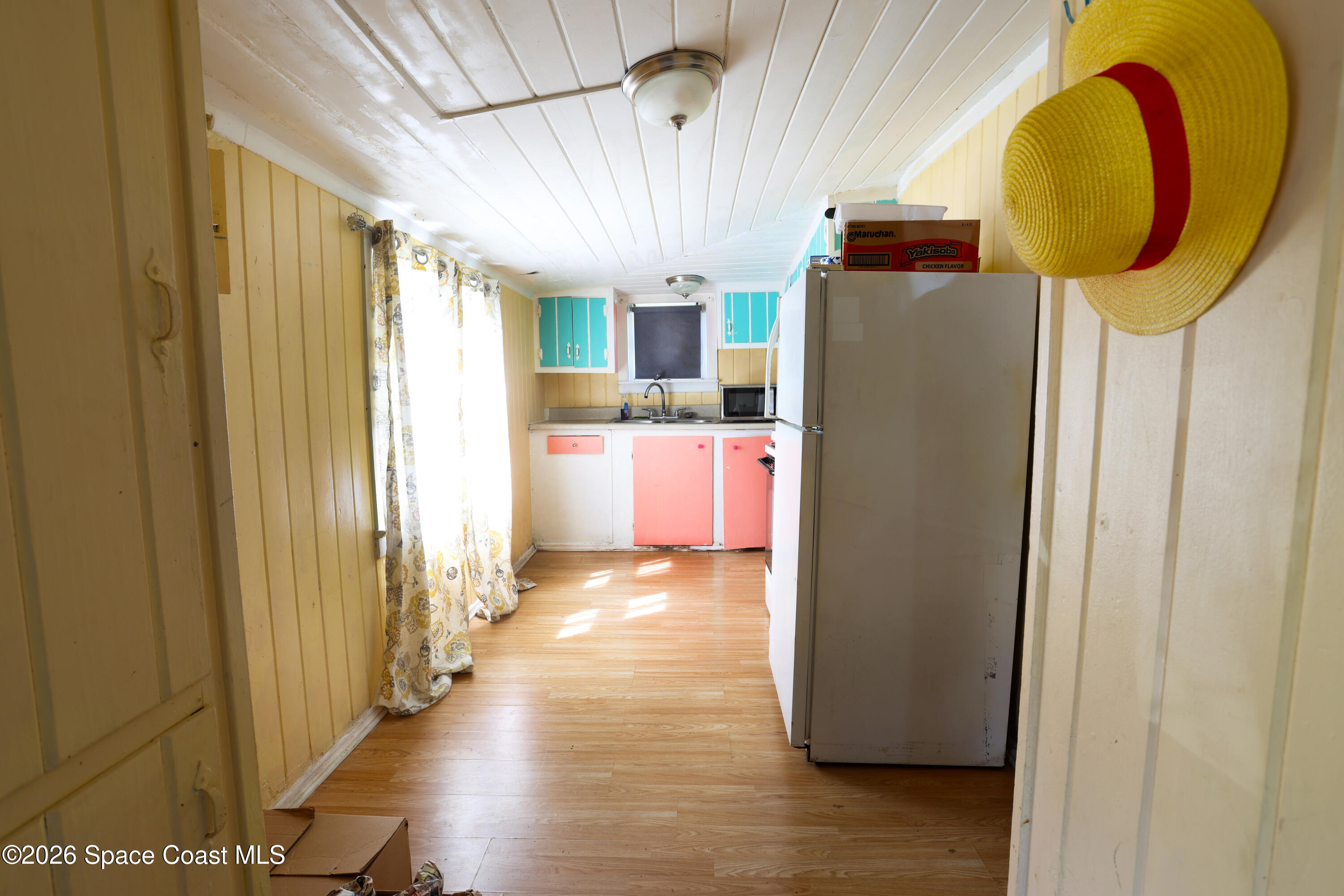 317 Pineda Street, Unit B Cocoa, FL 32922 - Photo 16 of 19 a view of a kitchen with wooden floor and furniture