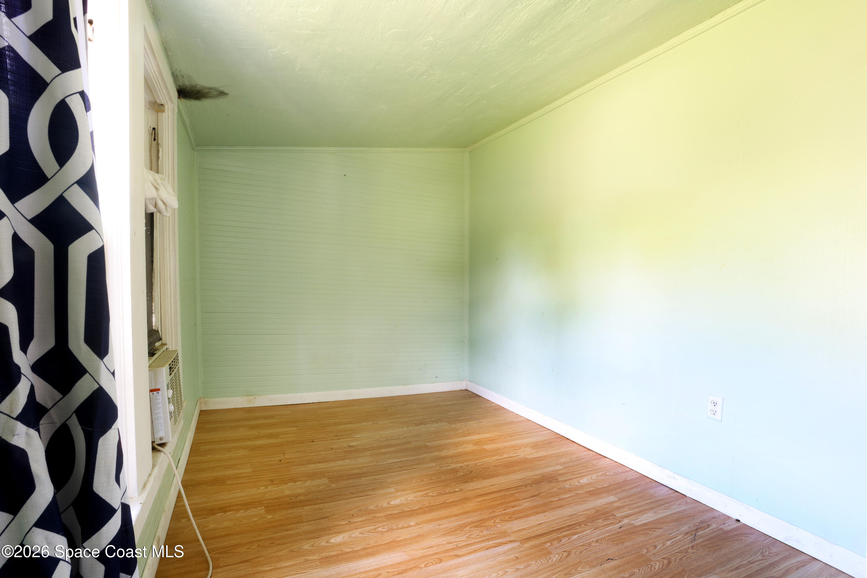 317 Pineda Street, Unit B Cocoa, FL 32922 - Photo 3 of 19 a view of a room with wooden floor and white walls