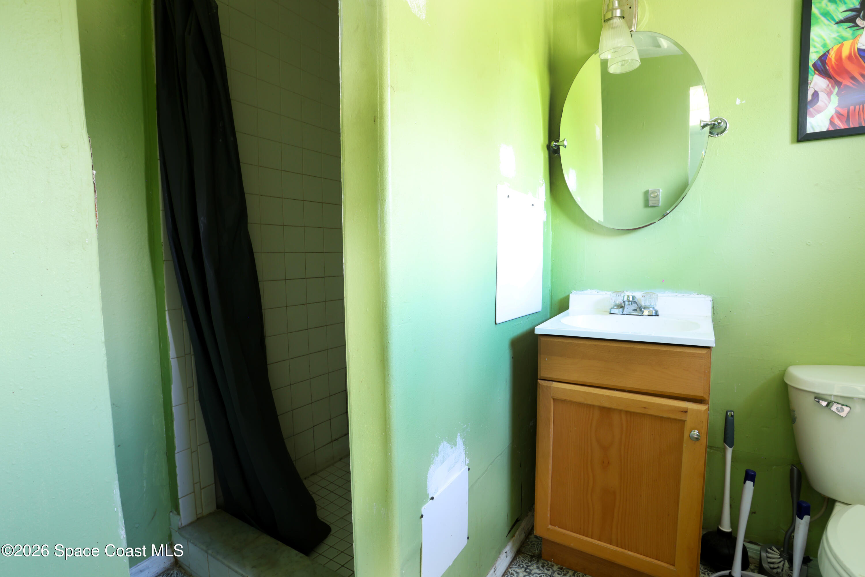 317 Pineda Street, Unit B Cocoa, FL 32922 - Photo 7 of 19 a bathroom with a sink mirror and toilet