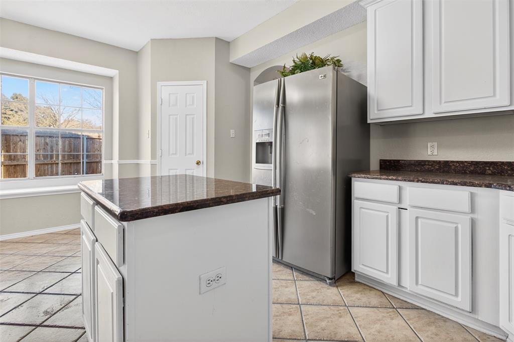 770 Whitman Drive Allen, TX 75002 - Photo 16 of 38 a kitchen with granite countertop a refrigerator and a sink