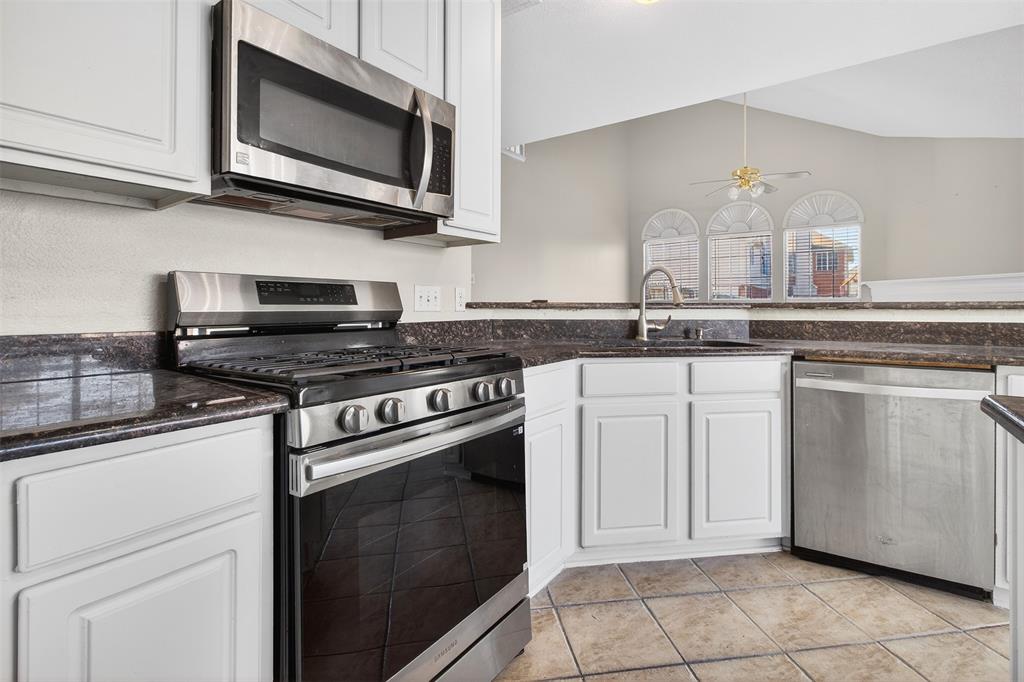 770 Whitman Drive Allen, TX 75002 - Photo 17 of 38 a kitchen with white cabinets stainless steel appliances and sink