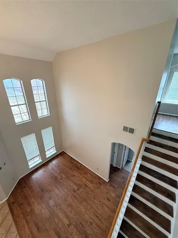 a view of an empty room and wooden floor