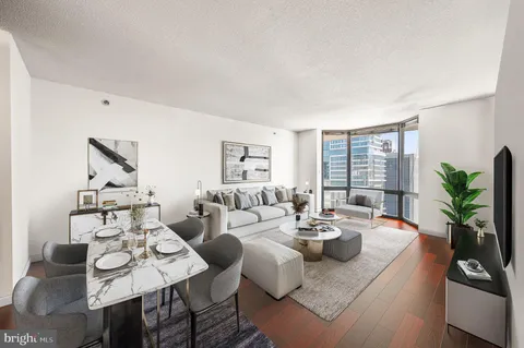 a living room with fireplace furniture and a potted plant