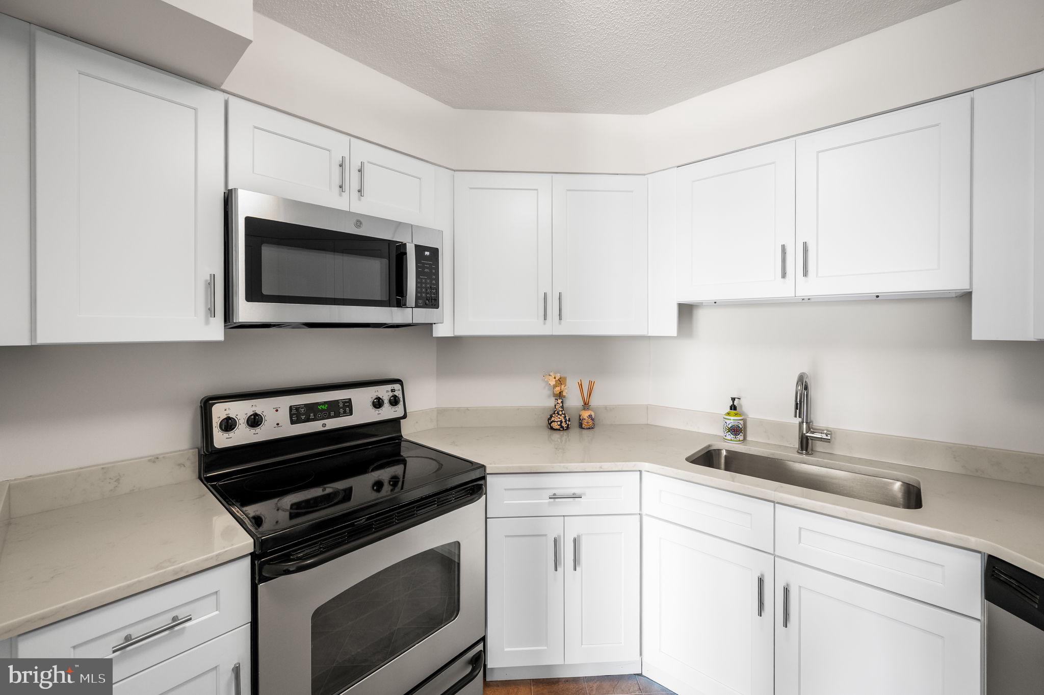 2020 Walnut Street, Unit 29D Philadelphia, PA 19103 - Photo 11 of 40 a kitchen with cabinets stainless steel appliances a sink and a counter top