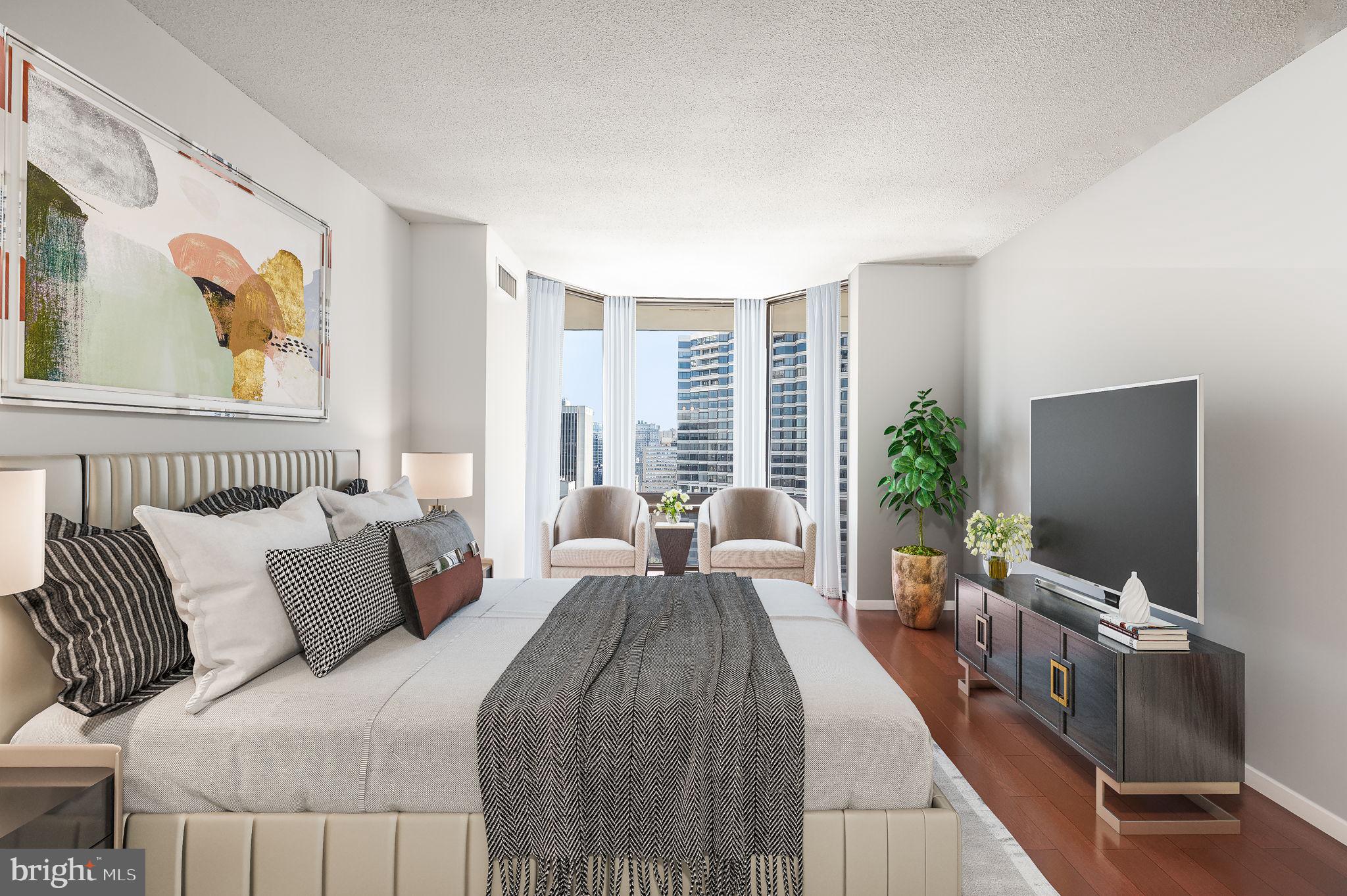 2020 Walnut Street, Unit 29D Philadelphia, PA 19103 - Photo 13 of 40 a bedroom with a bed and a flat screen tv