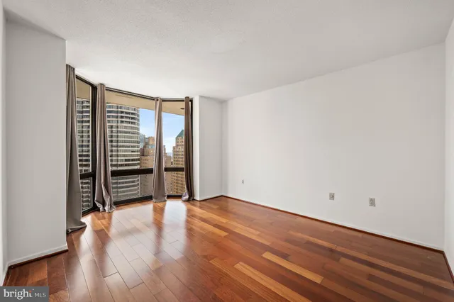 a view of an empty room with wooden floor