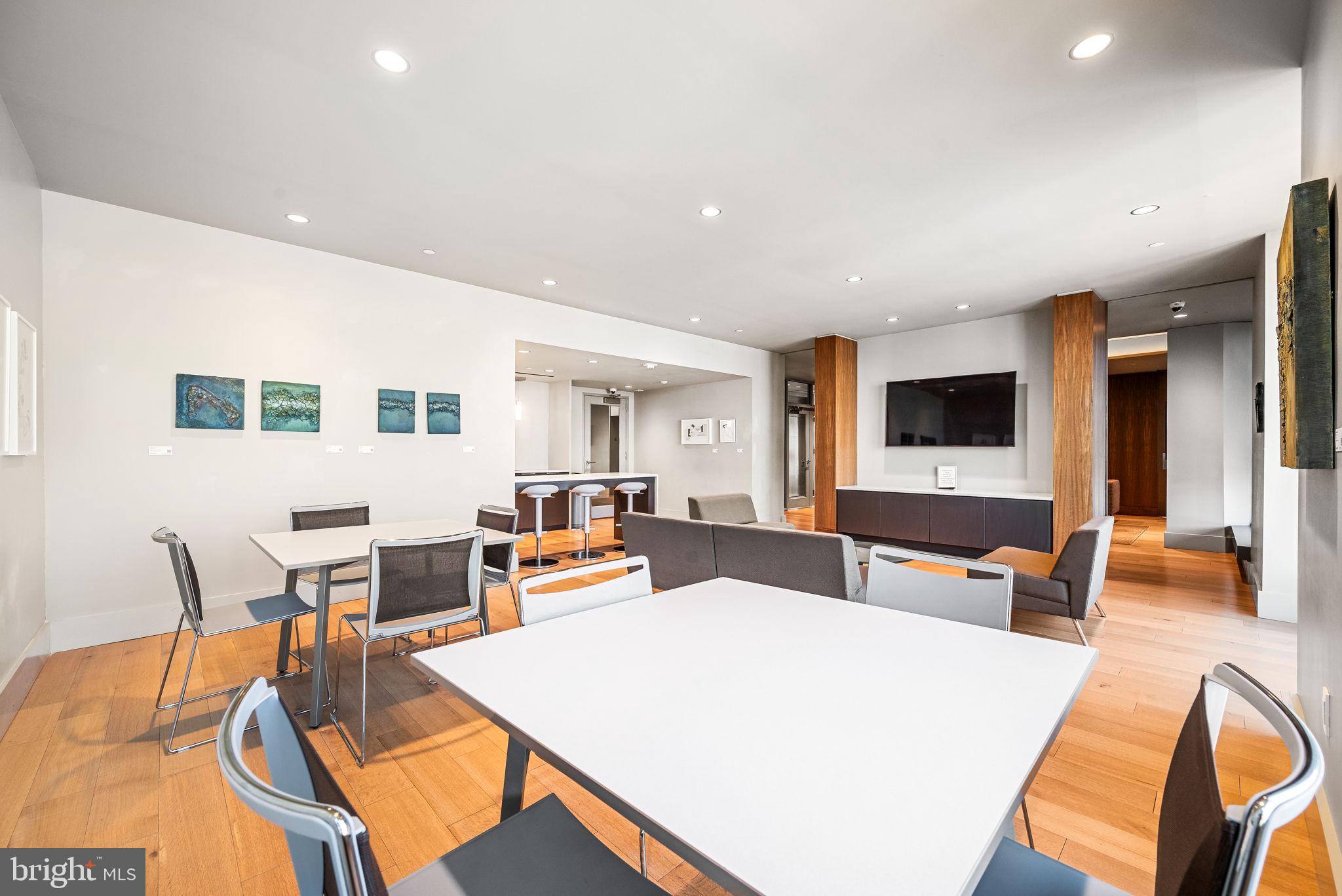 2020 Walnut Street, Unit 29D Philadelphia, PA 19103 - Photo 31 of 40 a living room with furniture a flat screen tv and kitchen view