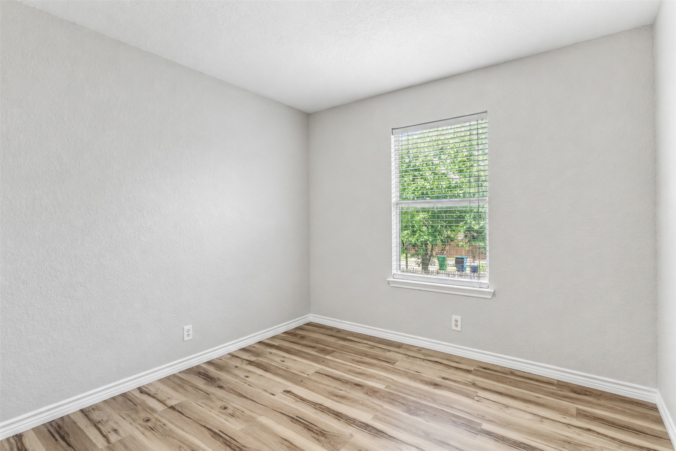 4523 Secure Lane Austin, TX 78725 - Photo 29 of 40 Natural light streams into this versatile space with durable wood-look flooring.