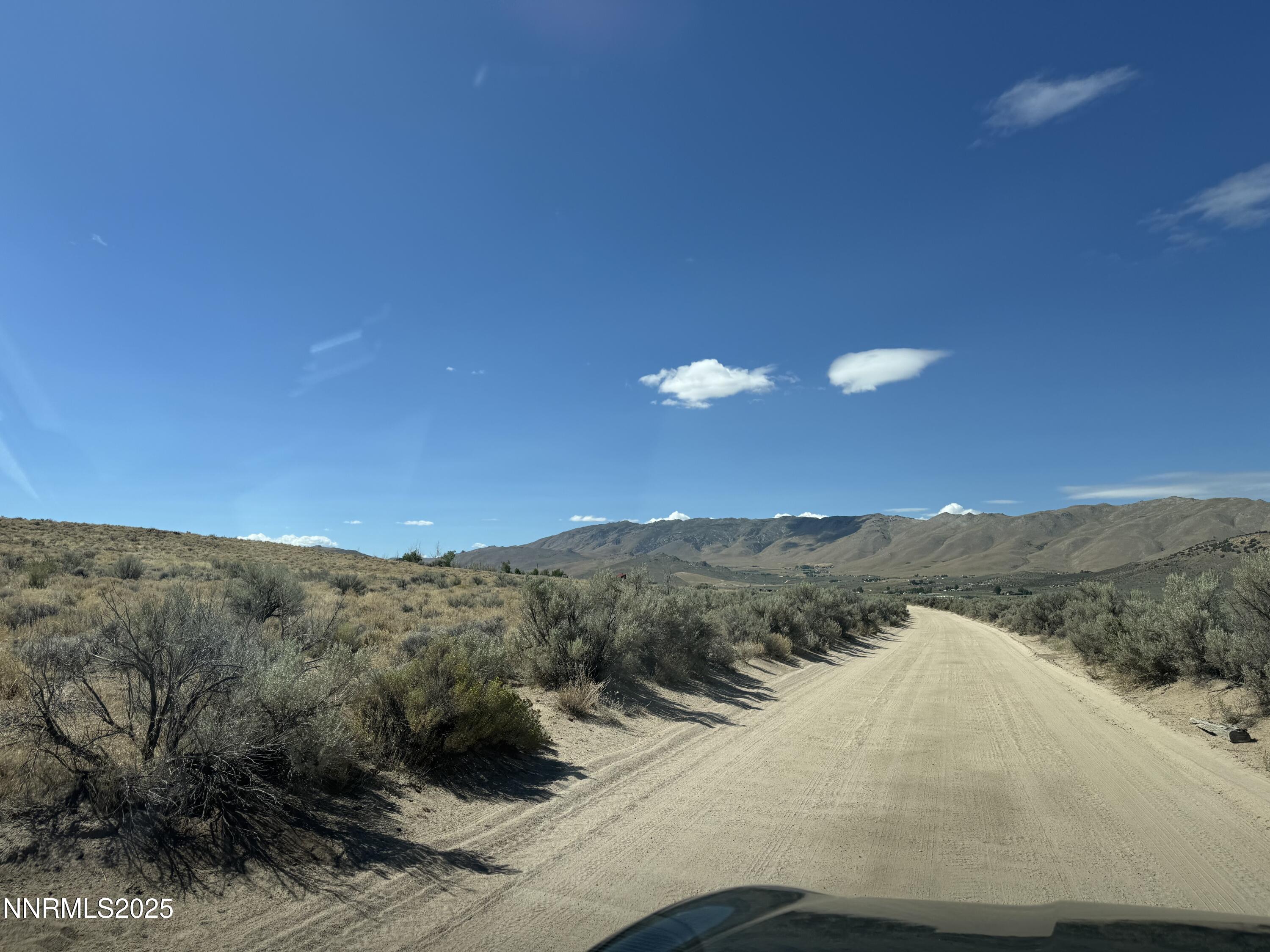 0 Dixie Lane, Unit 7836113 Reno, NV 89508 - Photo 7 of 9 a view of a dry yard with mountains in the background