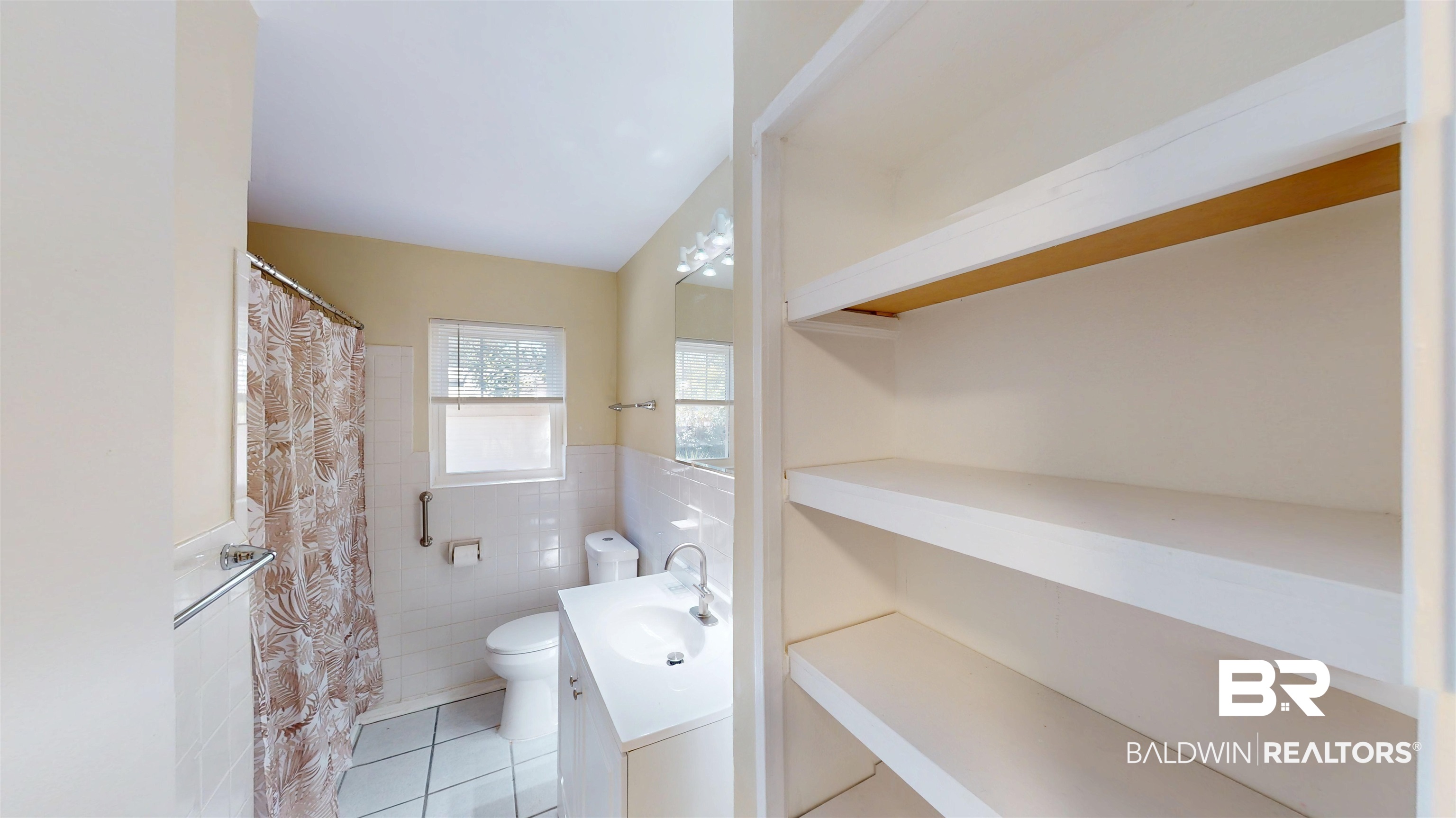 1471 Cedar Crescent Drive Mobile, AL 36605 - Photo 18 of 28 Bathroom featuring vanity, tile patterned flooring, curtained shower, wainscoting, and tile walls